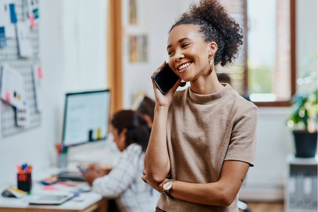 Woman measuring client satisfaction over the phone